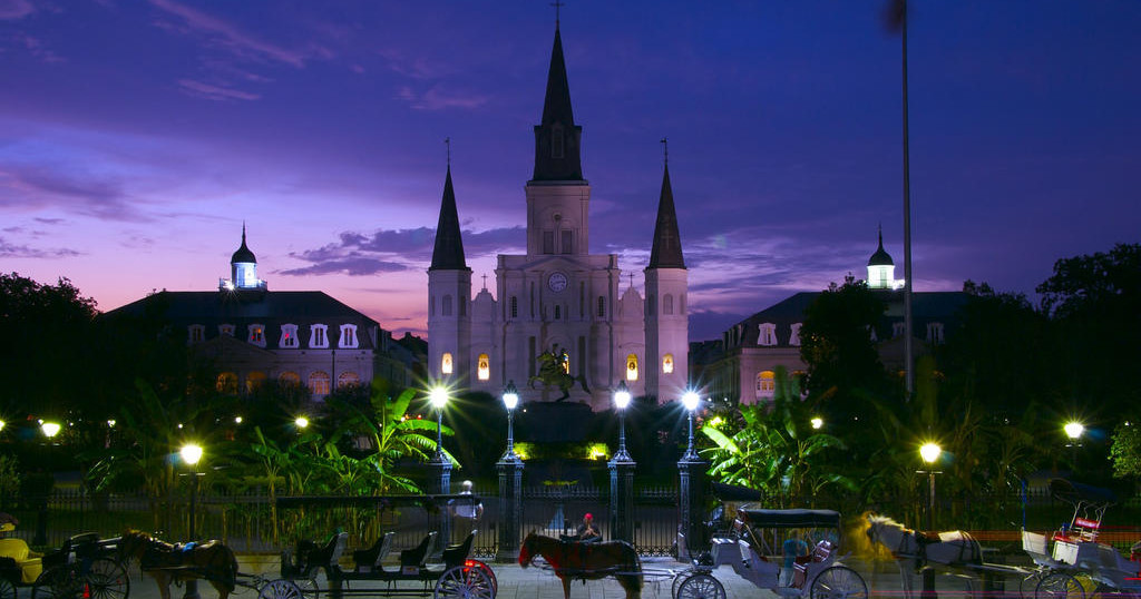 St. Louis Cathedral and Jackson Square at dusk with carriages lined up out front