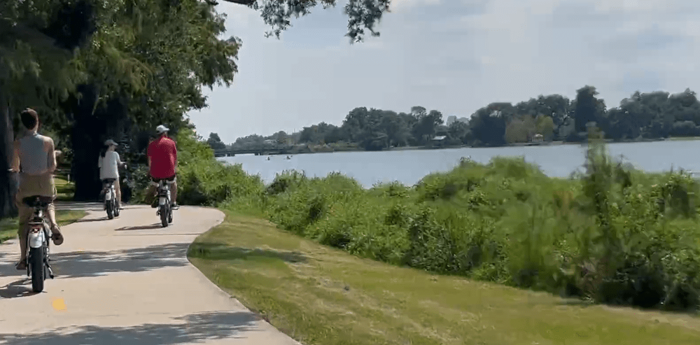E-bike tour riders cruising a lakeside path in New Orleans City Park